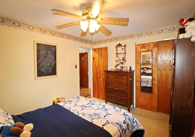 bedroom with carpet, ceiling fan, and a closet