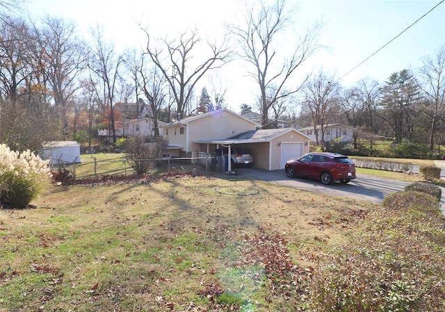 view of side of property featuring a garage and a yard