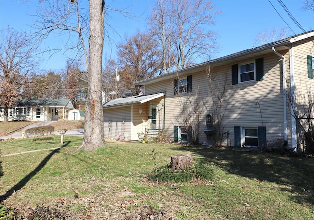 rear view of house featuring a yard