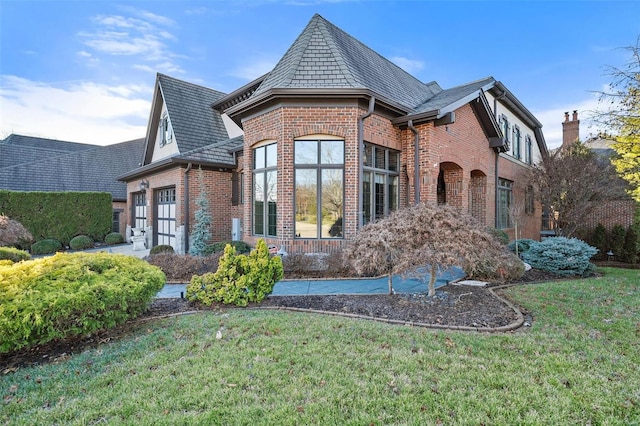 exterior space featuring a lawn and a garage