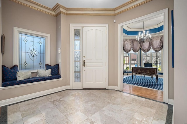 entryway featuring light hardwood / wood-style flooring, a chandelier, and ornamental molding