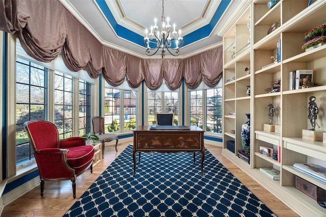 office featuring a raised ceiling, ornamental molding, parquet flooring, and an inviting chandelier