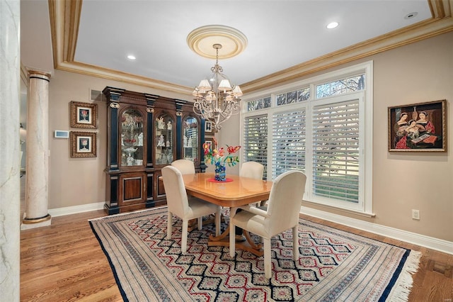 dining room with plenty of natural light, light hardwood / wood-style floors, and ornamental molding