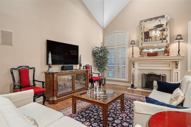 living room featuring hardwood / wood-style floors and high vaulted ceiling