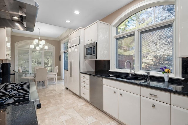 kitchen featuring sink, a chandelier, pendant lighting, white cabinets, and appliances with stainless steel finishes