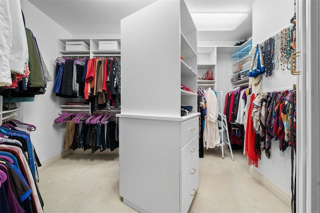 spacious closet featuring light colored carpet