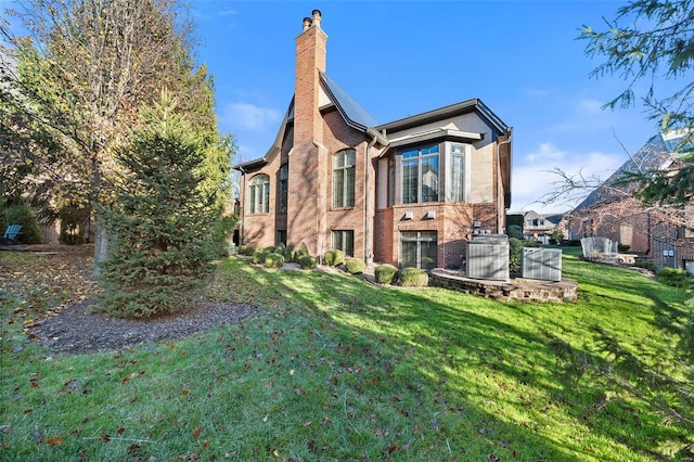 rear view of house featuring a lawn