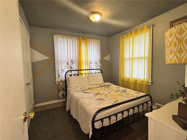 bedroom featuring dark colored carpet