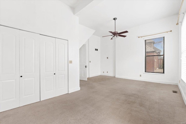 interior space featuring light colored carpet and ceiling fan