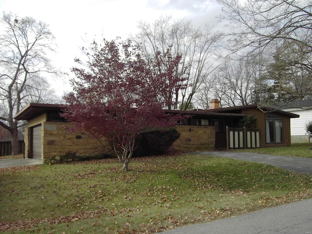 view of front of house with a front yard and a garage