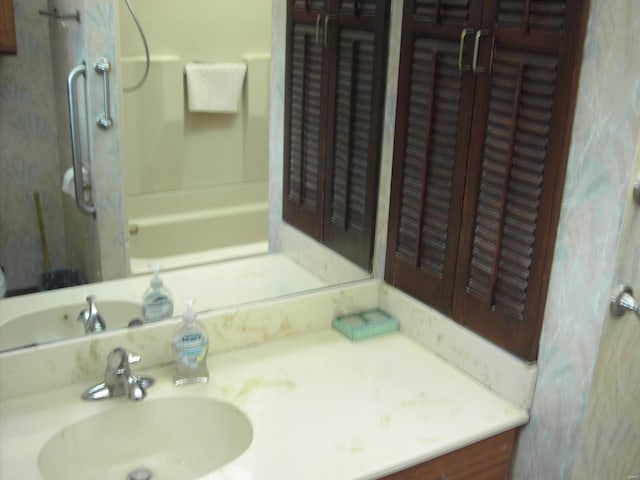 bathroom with vanity and  shower combination