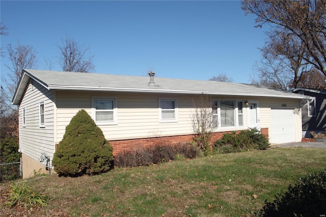 ranch-style home with a garage and a front lawn