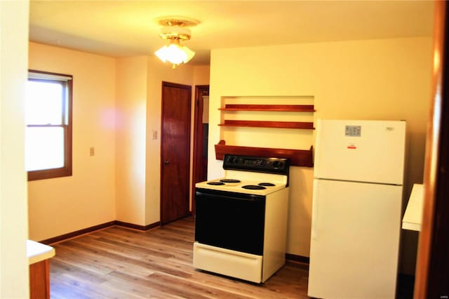 kitchen featuring light hardwood / wood-style floors and white appliances