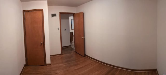 hallway featuring wood-type flooring