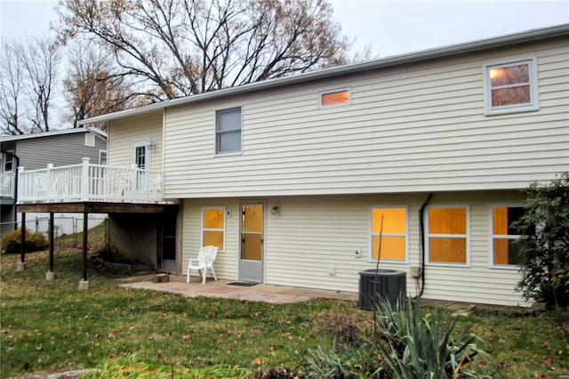 rear view of house with a yard, central AC, and a wooden deck