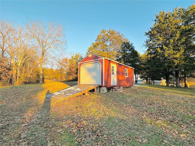 view of outbuilding with a garage and a yard