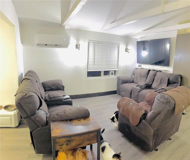 living room with vaulted ceiling, light hardwood / wood-style floors, and an AC wall unit