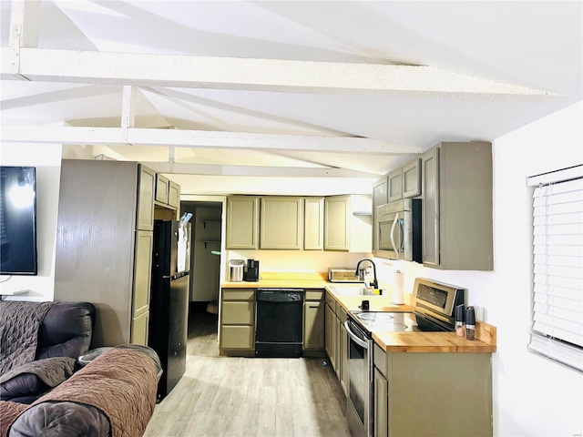 kitchen with butcher block countertops, vaulted ceiling with beams, appliances with stainless steel finishes, and light hardwood / wood-style flooring