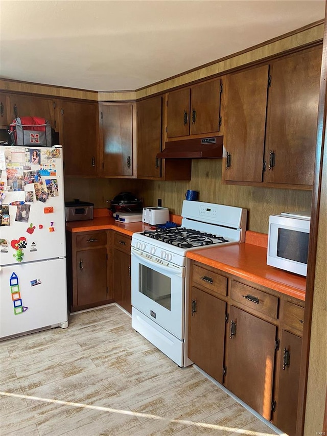 kitchen featuring light hardwood / wood-style floors and white appliances