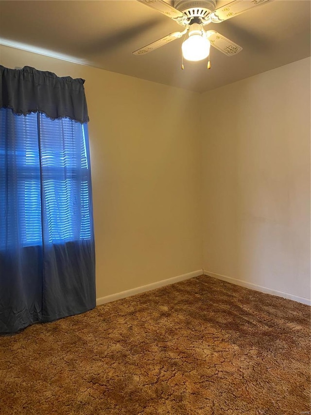 empty room featuring carpet flooring and ceiling fan