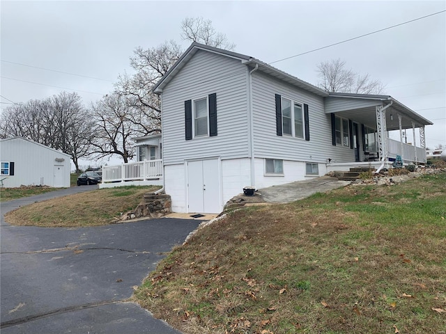 view of side of property with a porch and a yard