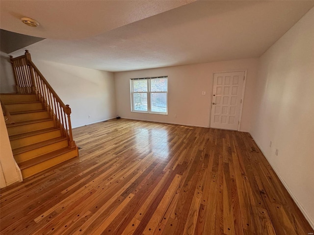 unfurnished living room featuring hardwood / wood-style floors