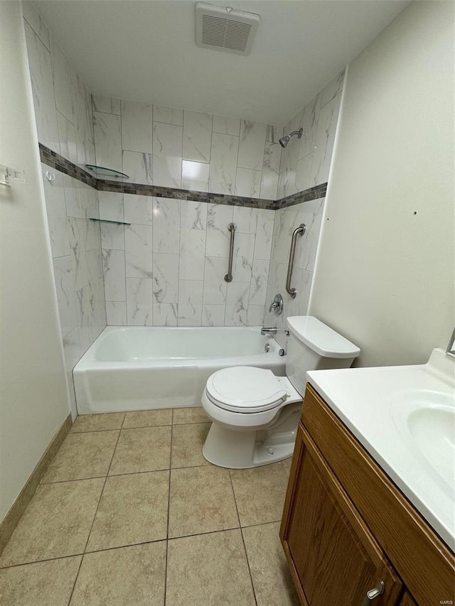 full bathroom featuring tile patterned flooring, vanity, tiled shower / bath combo, and toilet