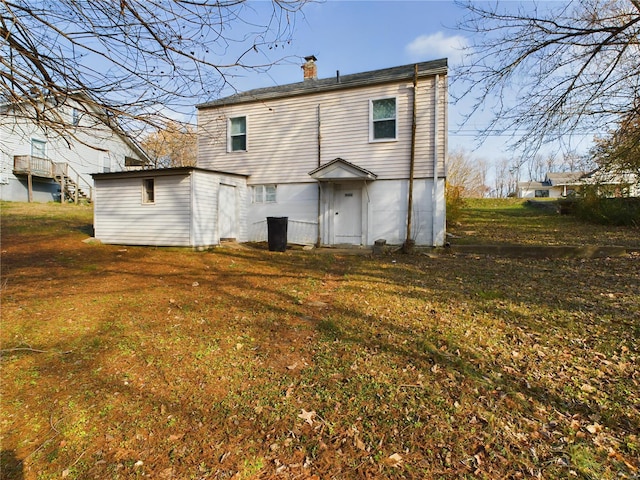 back of house with a lawn