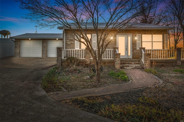 view of front of home featuring a porch and a garage