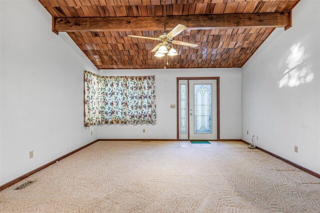 carpeted empty room featuring lofted ceiling with beams, ceiling fan, and wooden ceiling