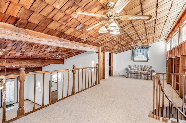 additional living space with beamed ceiling, ceiling fan, wooden ceiling, and light carpet