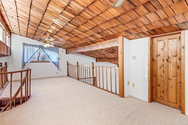 additional living space with vaulted ceiling with beams, ceiling fan, wood ceiling, and light carpet