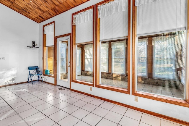 doorway with light tile patterned floors and wooden ceiling