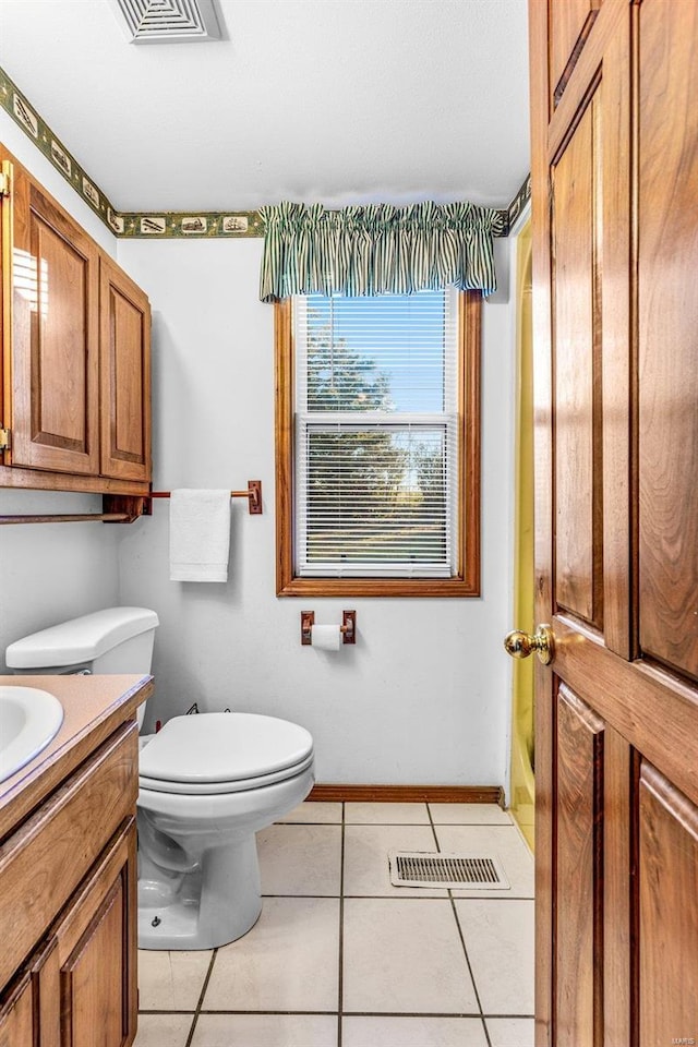 bathroom with tile patterned floors, vanity, and toilet