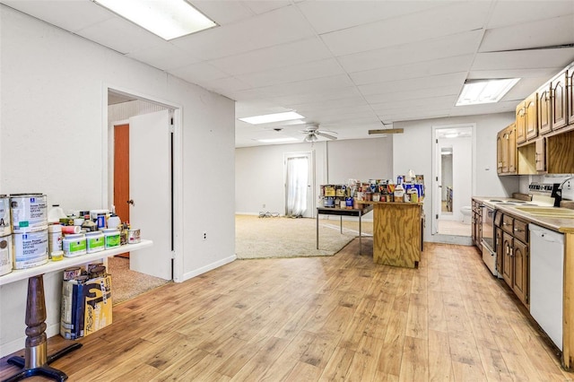 kitchen with light wood-type flooring, a drop ceiling, ceiling fan, dishwasher, and stainless steel electric range