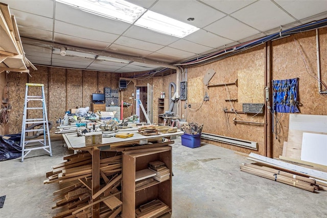 basement with a workshop area and a baseboard heating unit