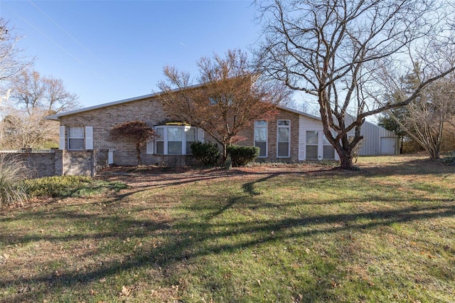 view of front facade featuring a front yard, a garage, and an outdoor structure