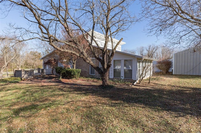 back of property featuring a yard