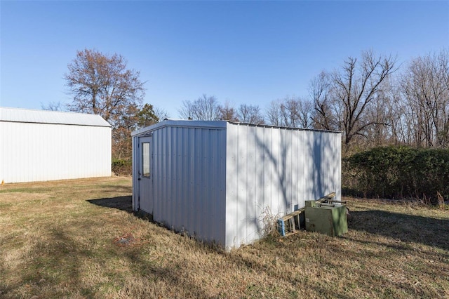 view of outbuilding with a lawn