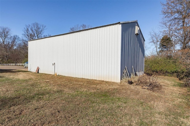 view of side of property featuring a yard and an outdoor structure