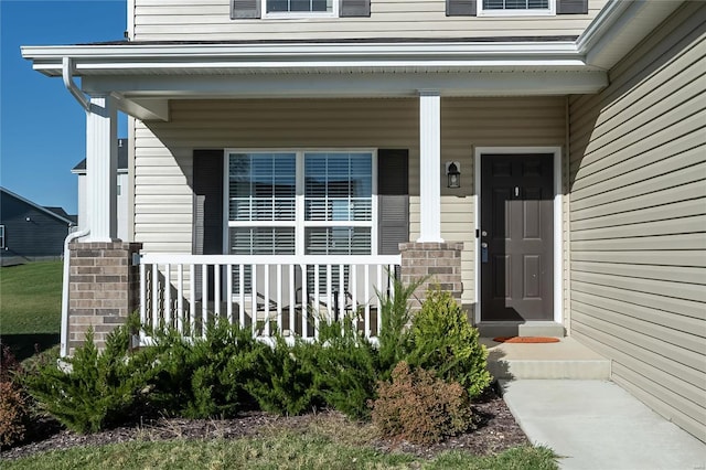 view of exterior entry featuring a porch