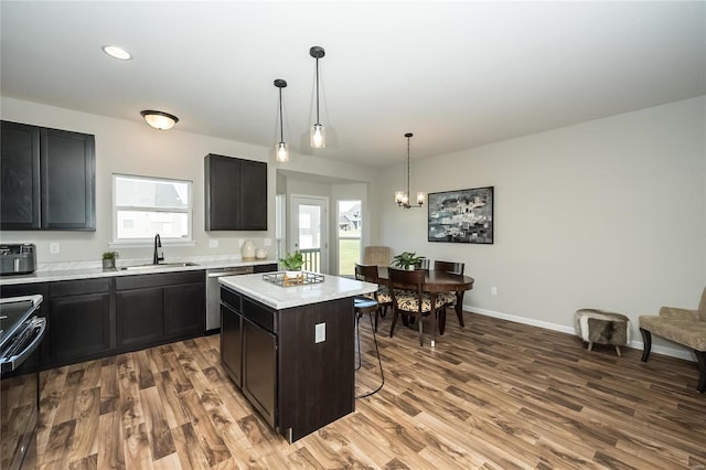 kitchen with hardwood / wood-style flooring, a center island, a healthy amount of sunlight, and sink