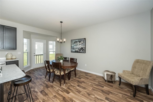 dining room featuring dark hardwood / wood-style floors and a notable chandelier