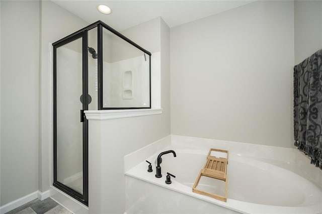 bathroom with separate shower and tub