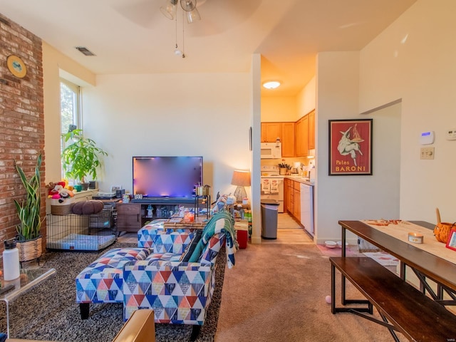 living room with light colored carpet and ceiling fan