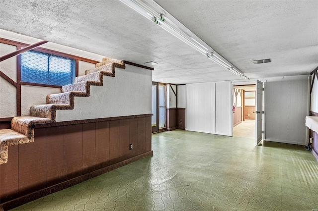 basement featuring a textured ceiling