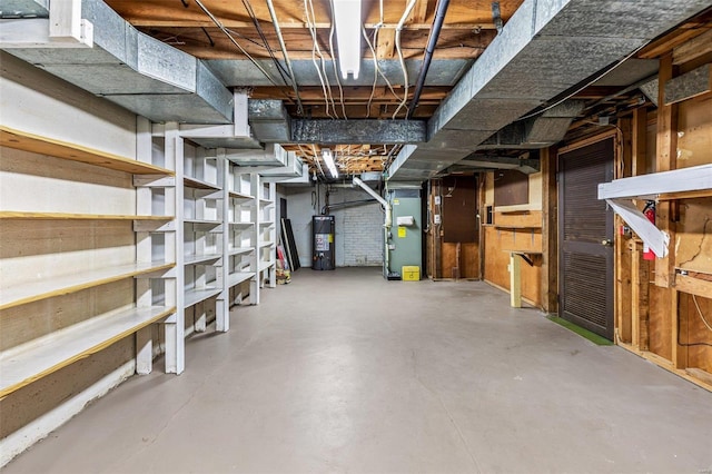 basement featuring heating unit and water heater