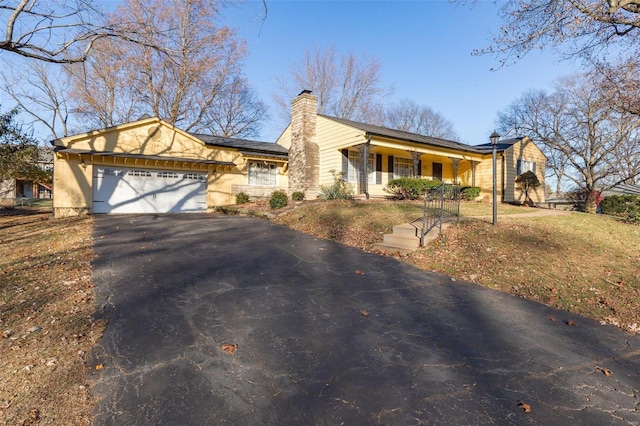 single story home with covered porch and a garage