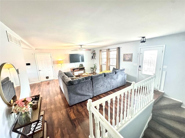 living room with ceiling fan and dark wood-type flooring