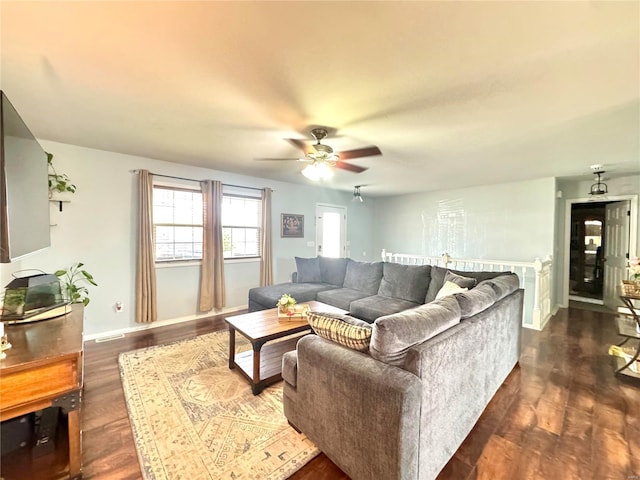 living room with ceiling fan and dark hardwood / wood-style floors